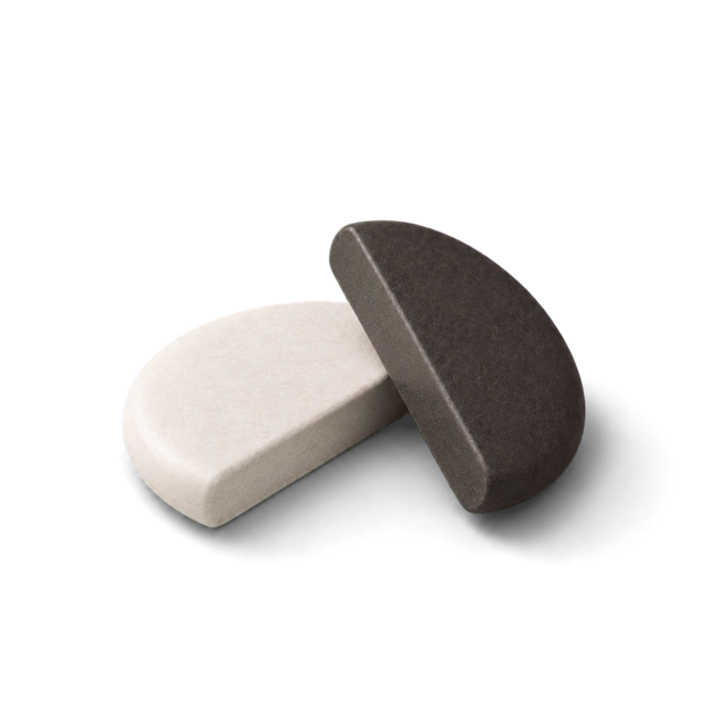 A white and a graphite stone half resting together