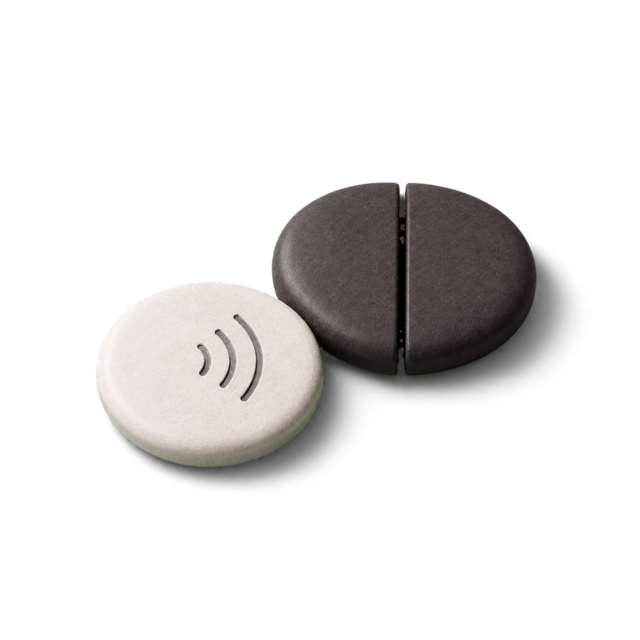 An NFC token beside the split stone